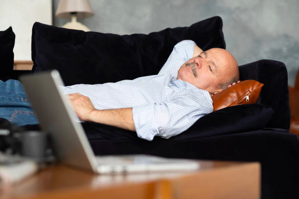 Older man naps on couch